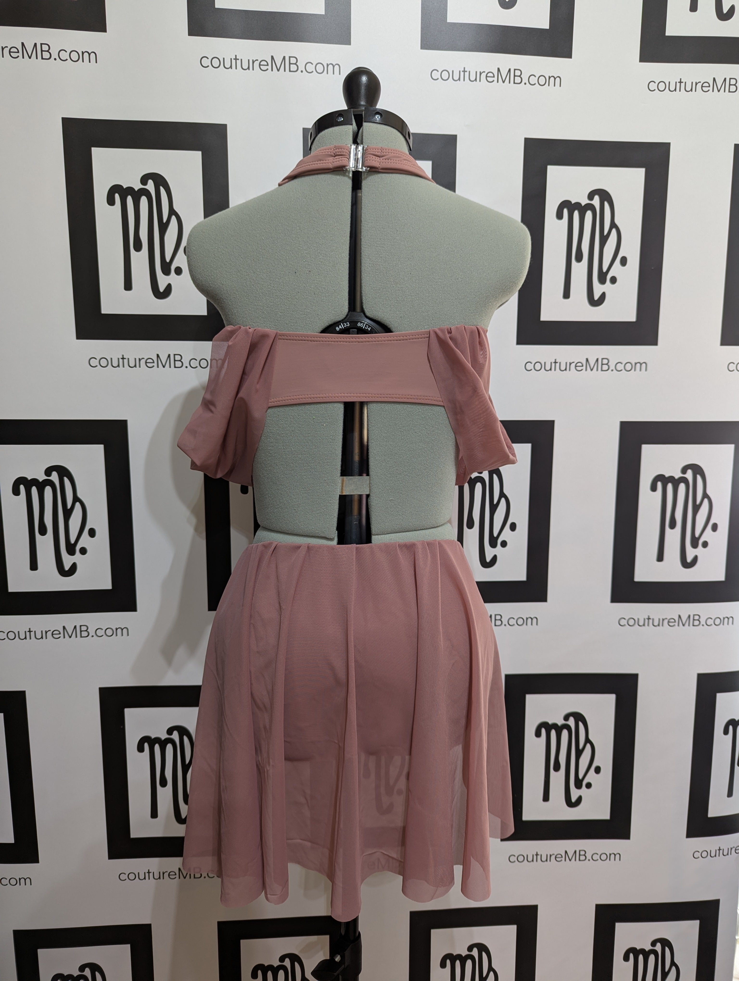 Leotard with draped arms, skirt and center ring